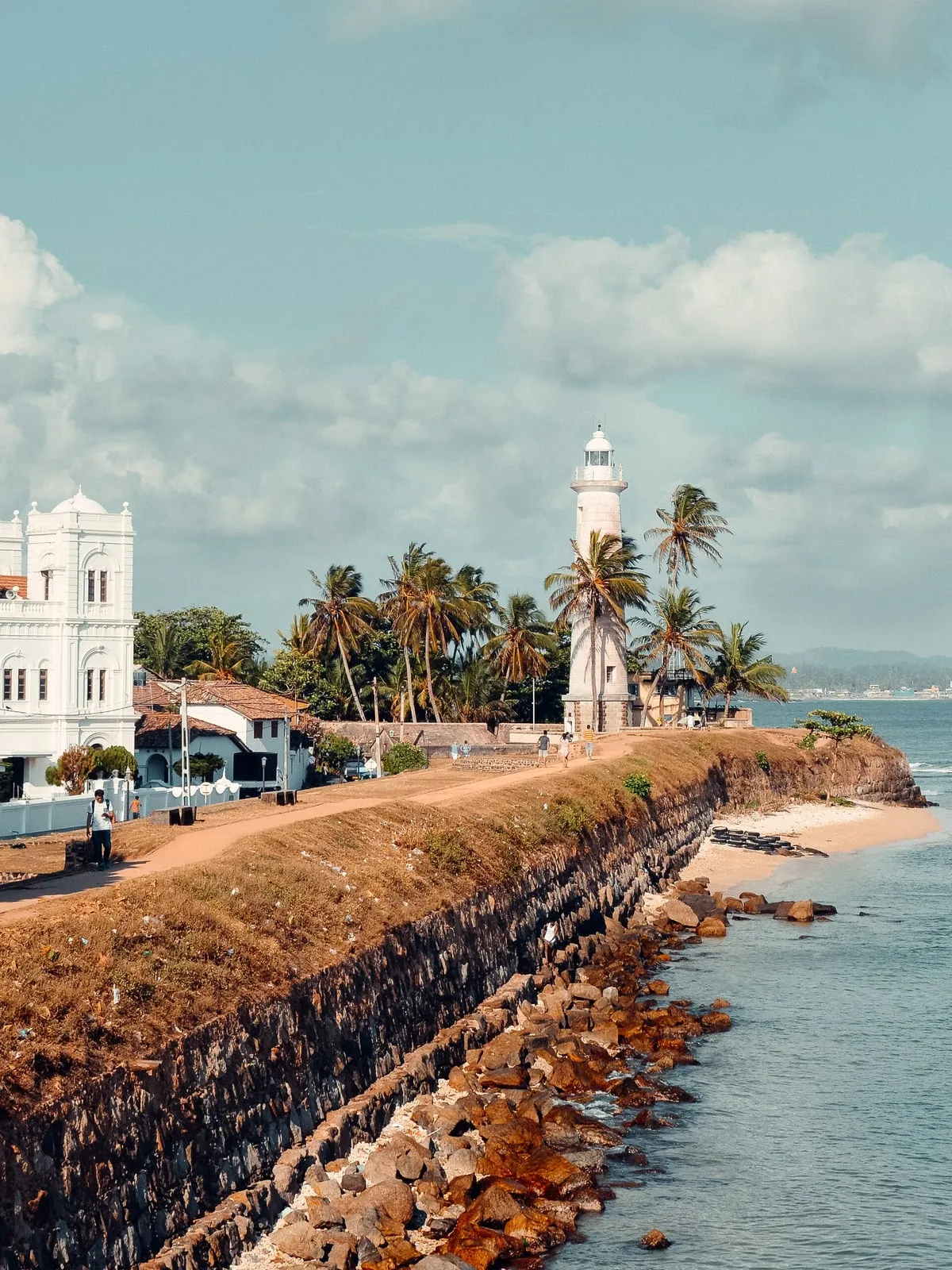 The lighthouse and rampart of Galle Fort above the sea