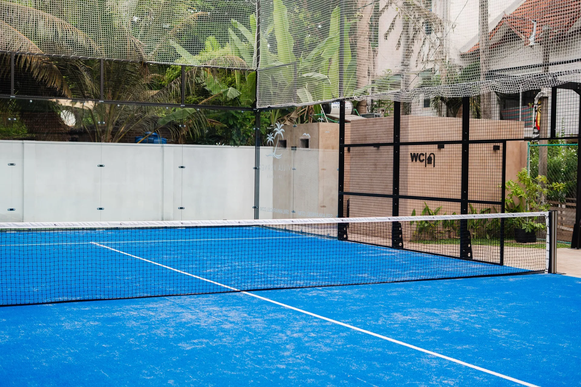 The Villa Verner panoramic padel court beneath the coconut palms
