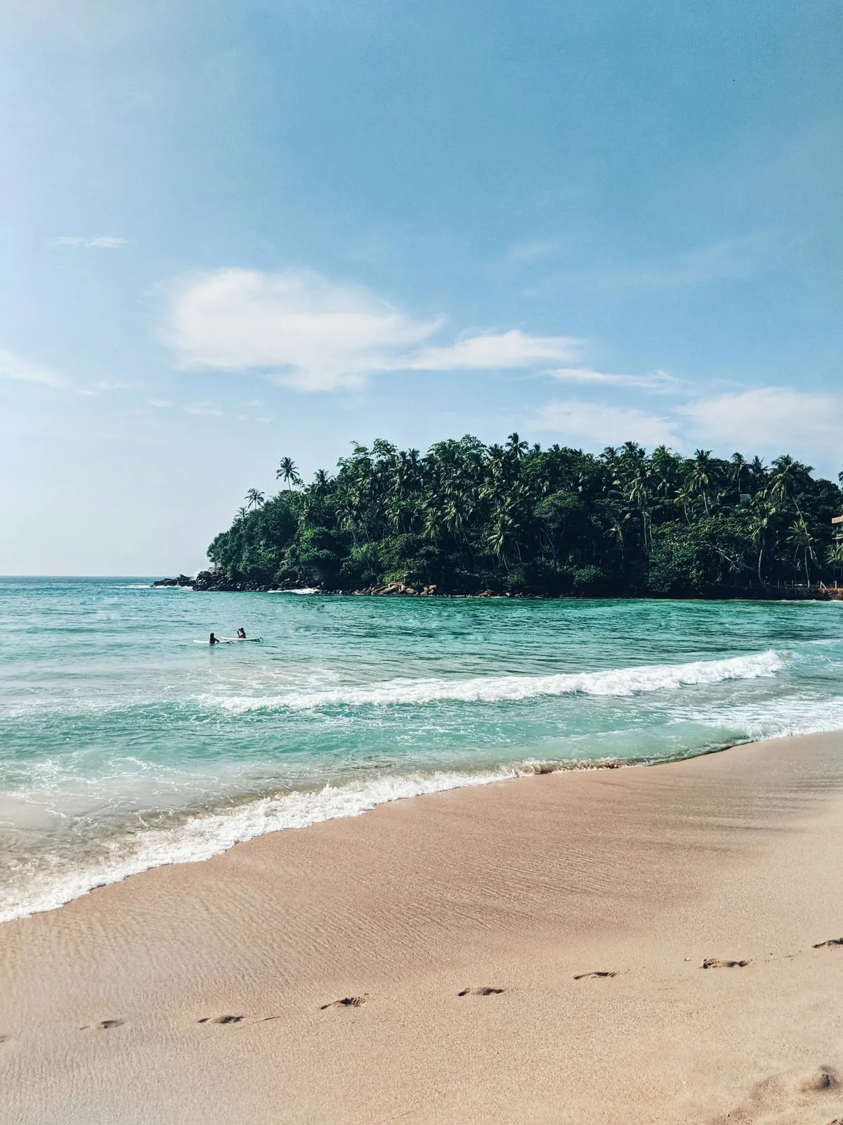 The horseshoe bay of Hiriketiya and its palm-covered headland